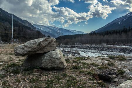 Stone kept one over other to form a building at the top of mountain.Landscape of mountain range covered with snow in Manali during summersの写真素材