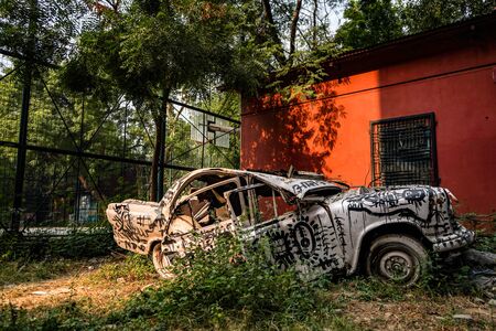 New Delhi, Delhi India- May 31 2020:Photo of a damaged and destroyed car painted with graffiti.の写真素材