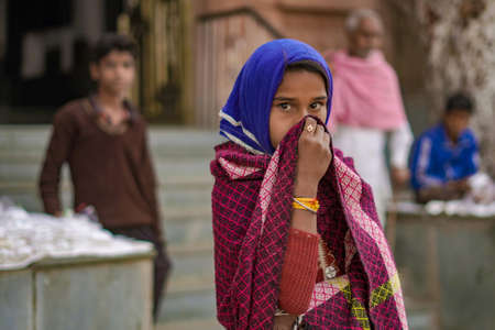 Pushkar, Rajasthan / India- June 5 2020 : A girl in a saree holding a part of it in front of her face, hiding her face.のeditorial素材
