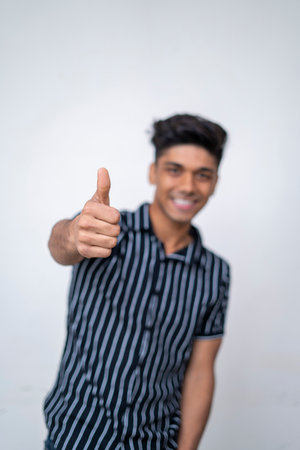 close up of handsome cute asian boy hand showing thumbs up into the camera.の写真素材