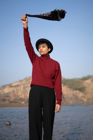Young beautiful girl standing near a lake in the mountains with holding a hanky on her hand.の写真素材