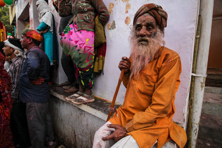 Mathura, Uttar Pradesh, India- January 6 2020: Portrait of a shant sadhu old man, sitting on a rock captured in mathura during the festival of Holi.のeditorial素材