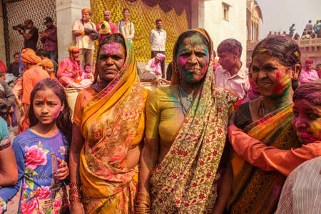 Mathura, Uttar Pradesh, India- January 28 2020: two widowed women roaming around the temple in nandgaon during the festival of holi. Widow women playing holi in mathura.のeditorial素材