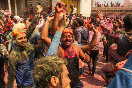 Mathura, Uttar Pradesh, India- January 6 2020: crowd of mathura celebrating holi by playing with colors captured in slow shutter speed for a motion blur effect.のeditorial素材