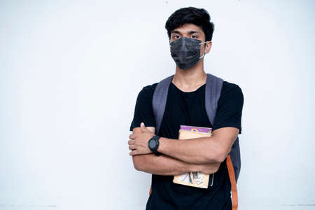 Young indian college boy getting ready for college after the lock down is over. College and School reopen after lock down.の写真素材