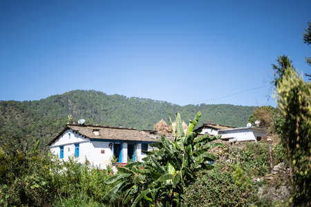 A traditional house situated in the mountains captured during daylight. A traditional house situated in almora.の写真素材