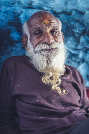 Portrait of an old indian man, old aged man with wrinkles on his face smiling into the camera.の写真素材