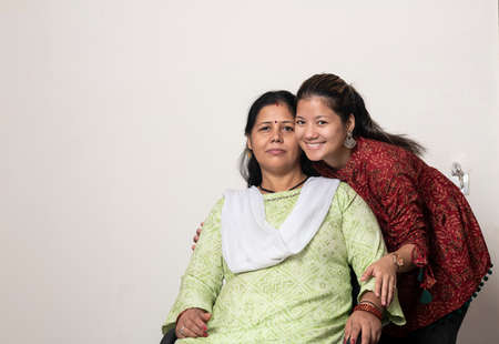 A portrait of a young indian girl with her mother, mother and daughter loveの写真素材