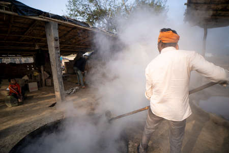 Delhi, India- January 12 2022- indian men making jaggery out of sugarcane juice in Uttar pradesh. Men working in small business in villages.のeditorial素材