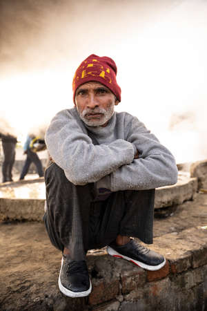 Moradabad, Uttar Pradesh- January 12 2022- Portrait of an old aged man from village sitting on a stone pedestal.のeditorial素材
