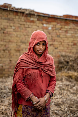 Garh Mukteshwar, Uttar Pradesh- January 13 2022 - A portrait of an Indian female worker in the factory. A female labor working in the jaggery making factory.のeditorial素材
