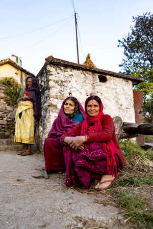 Almora, Uttarakhand - January 3 2022- Two indian elderly aged women sitting on the road and looking into the camera. Indian traditional women wearing indian clothes.のeditorial素材