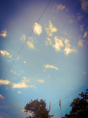 A closeup view of blue sky with green nature viewの写真素材