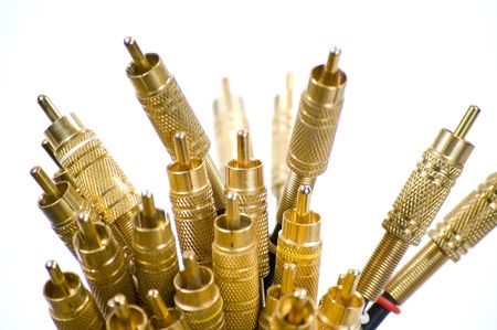 A close-up of a bundle of gold plated RCA jacks pointing upwards on a white background.の写真素材