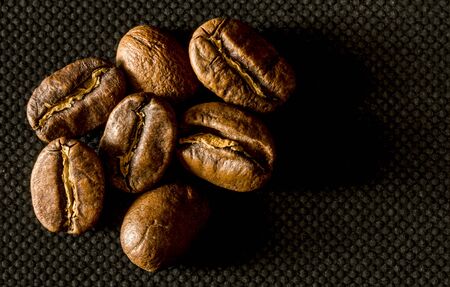 Macro close up of coffee beans on a black backgroundの写真素材