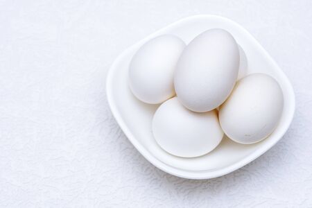 Close up of white eggs in a white bowlの写真素材