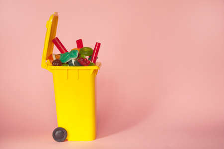 a yellow trash can full of jelly beans