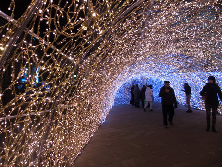 Genova, Italy - 12/15/2018:An amazing christmas decoration lights on the streets of Genova in winter with an artistic background and some people enjoing the momentのeditorial素材