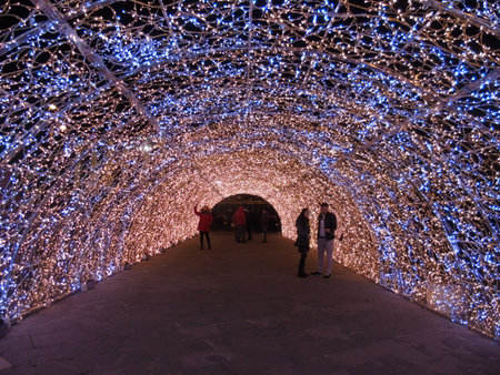 Genova, Italy - 12/15/2018:An amazing christmas decoration lights on the streets of Genova in winter with an artistic background and some people enjoing the momentのeditorial素材