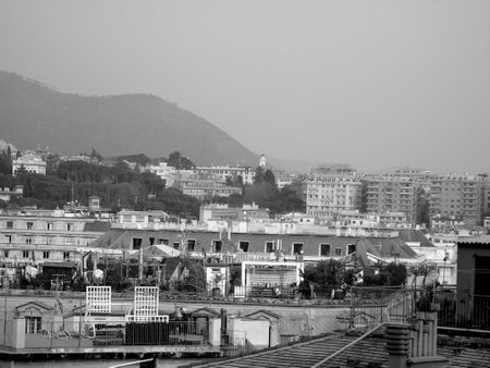 Genoa, Italy - 02/04/2019: An amazing caption of the city of Genoa from the hills in winter days, with a great gray sky, some tall skyscrapers and beautiful old buildingsのeditorial素材