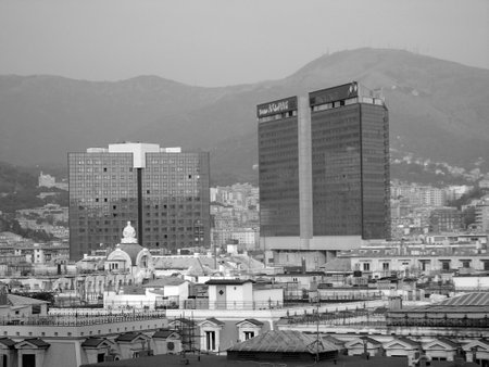 Genoa, Italy - 02/04/2019: An amazing caption of the city of Genoa from the hills in winter days, with a great gray sky, some tall skyscrapers and beautiful old buildingsのeditorial素材