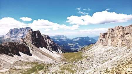 Alpine scenic place with magical Dolomites mountains in the background, amazing clouds and blue...