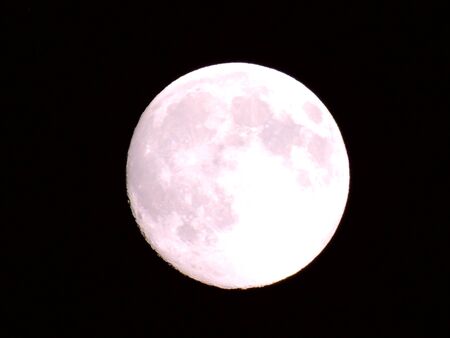 An amazing photography of the full moon over the city of Genoaの写真素材