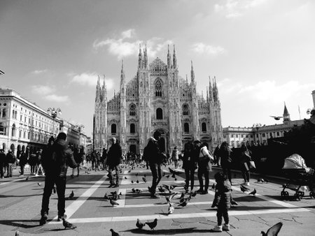 Milan, Italy - 12/25/2019: An amazing caption of the Duomo of Milan in winter days with some people enjoying the evening and beautiful black and white background, and beautiful photo of some skylinesのeditorial素材