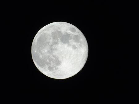 An amazing photography of the full moon over the city of Genoaの写真素材