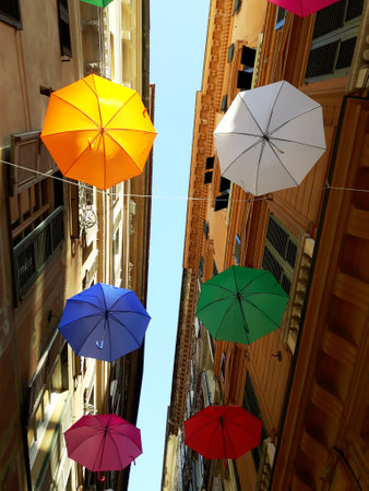 Genova, Italy - 06/01/2020: Bright abstract background of jumble of rainbow colored umbrellas over the city celebrating gay prideのeditorial素材