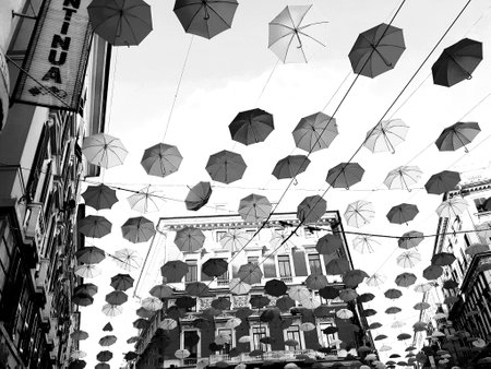 Genova, Italy - 06/01/2020: Bright abstract background of jumble of rainbow colored umbrellas over the city celebrating gay prideのeditorial素材