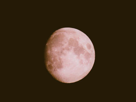 Liguria, Italy - 07/22/2020: Beautiful photography of the moonlight in the different phases with different colors. Black sky and little stars in the background.の写真素材