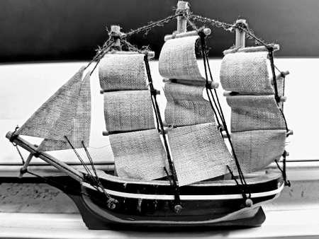 Hand made sail boat over the table in black and white background.の写真素材