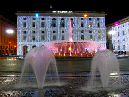 Genova, Italy - 12/02/2020: An amazing christmas decoration lights on the streets of Genova in winter with an artistic background and some people enjoing the momentのeditorial素材