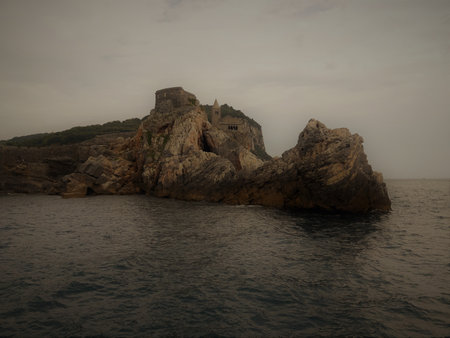 Liguria, Italy - June 15, 2020: Traveling around the ligurian seaside. Panoramic view to the seaside and the old villages. An amazing caption of the medieval colored houses with gray sky.のeditorial素材
