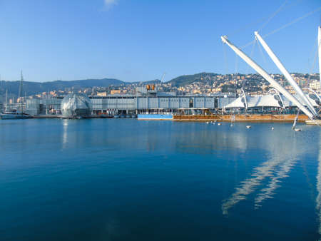 Genoa, Italy- April 01, 2021: Panoramic view of the waterfront and the old italian sea port in Genova by spring with blue sky and clear water.の写真素材