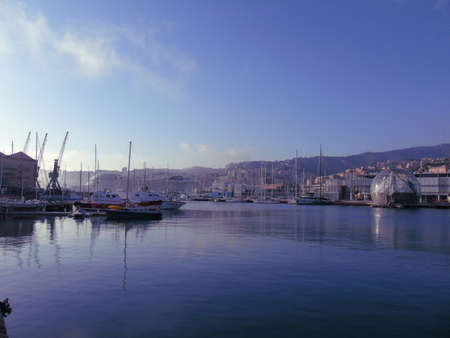 Genoa, Italy- April 01, 2021: Panoramic view of the waterfront and the old italian sea port in Genova by spring with blue sky and clear water.の写真素材