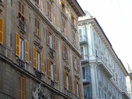 Genova, Italy- July 22, 2021: Antique stone brick castle house wooden window. Aged classic building facade. Vintage building facade wall. Classic European architecture. Postcard wallpaper.のeditorial素材
