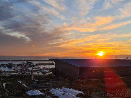 Genova, Italy - November 02, 2021: Beautiful sunset over the sea and the city. Clouds over the sun.Natural colors.のeditorial素材