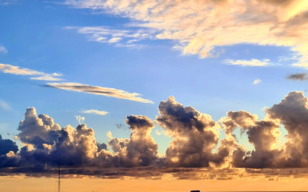 Genova, Italy - January 1, 2021: An amazing photography of the sunset in winter days over the sea and the port of Genova with beautiful red sky and some amazing colored clouds in the background.のeditorial素材