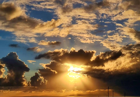 Genova, Italy - January 1, 2021: An amazing photography of the sunset in winter days over the sea and the port of Genova with beautiful red sky and some amazing colored clouds in the background.のeditorial素材