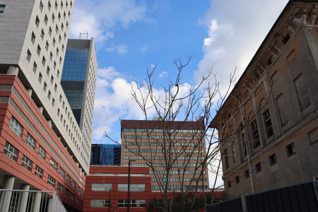 Genova, Italy-January 29, 2022: Beautiful modern high-rise buildings against the sky. 3d illustration on the theme of business success and technology. clouds reflection on the mirror.Industrial zone.のeditorial素材