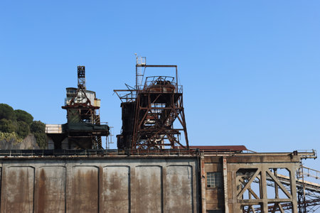 SAVONA, ITALY - February 12, 2022 - The port of Savona in the heart of the city on the italian riviera. Some old  container lifter near the new area. Beautiful small boats parked.のeditorial素材