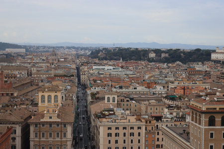 ROME, ITALY - February 05, 2022: Panoramic view around the Colosseum in city of Rome, Italy. Cold and gray sky in the background. Macro photography of the green parks with the old buildings.のeditorial素材