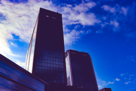 Genova, Italy-January 29, 2022: Beautiful modern high-rise buildings against the sky. 3d illustration on the theme of business success and technology. clouds reflection on the mirrのeditorial素材