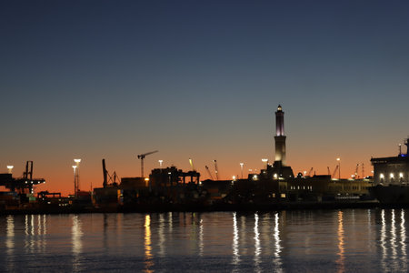 Genova, Italy - July 02, 2022: View of the city and the old harbor (Porto Antico) by night. City lights reflection over the water.のeditorial素材