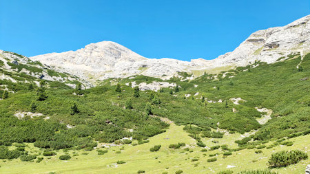 Val Badia, Italy-July 18, 2022: The italian Dolomites behind the small village of Corvara in summer days with beaitiful blue sky in the background. Green nature in the middle of thの写真素材