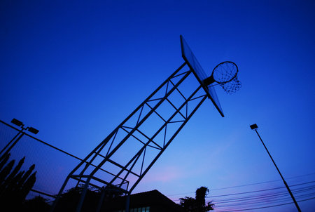 the silhouette of basketball net in morning on blue sky backgroundの写真素材