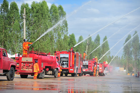 the group of firefighters man are inject spray the water to fire accident on buildingの写真素材