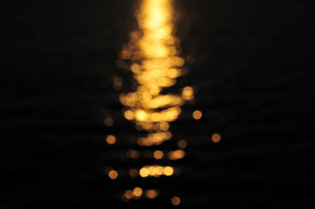 the reflection of light on water surface in sunset